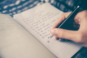 Hand writing a checklist in a book